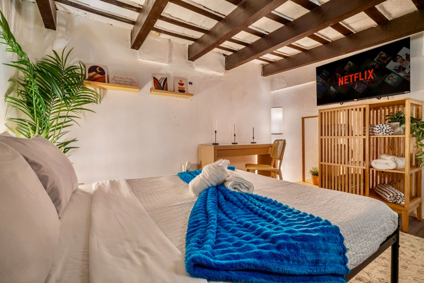 Bedroom with a blue blanket on the bed — La Cueva Loft Rustic Colonial Romance, Old San Juan