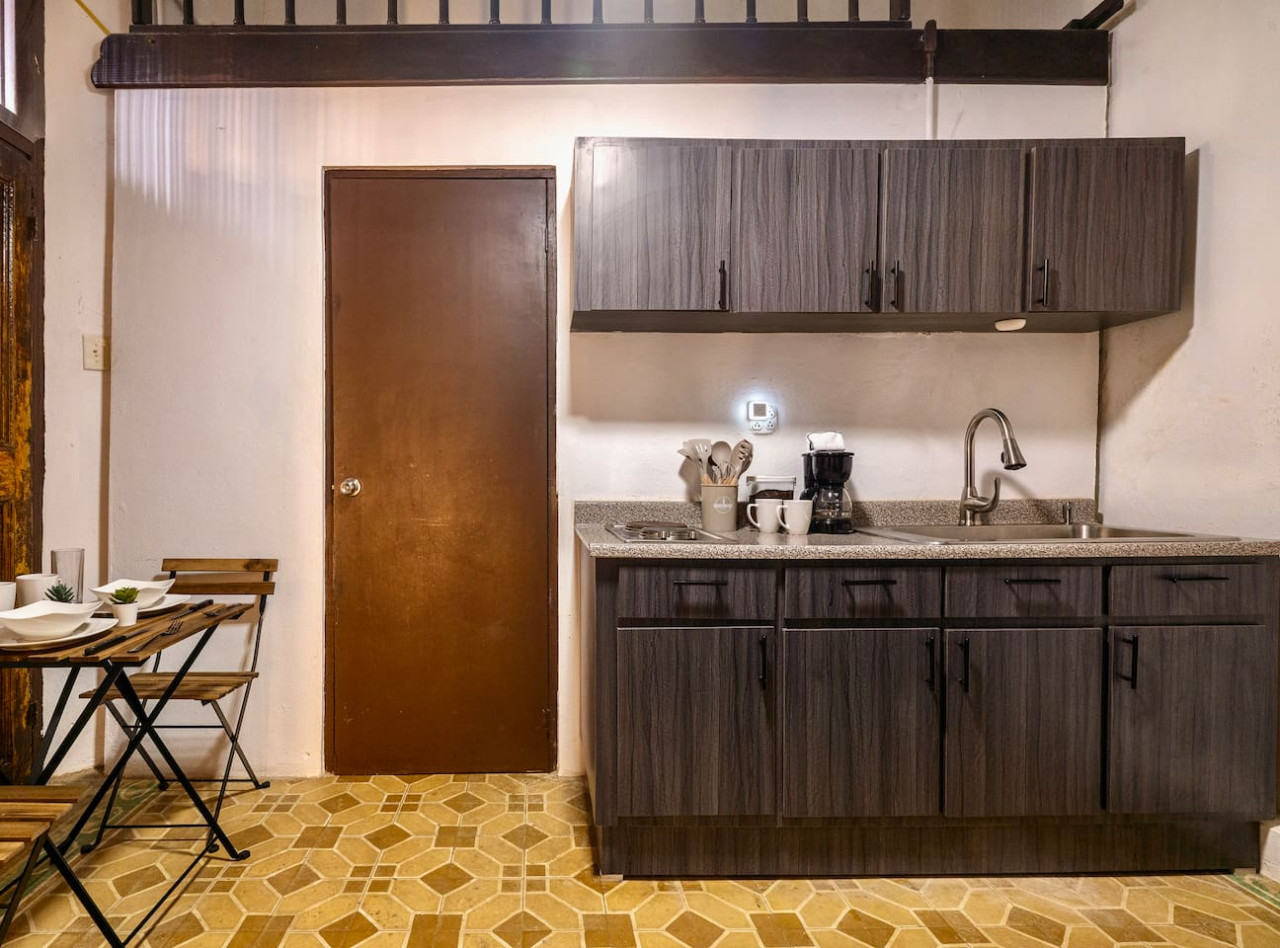 Kitchen with a doorway leading to a bedroom — La Cueva Loft Rustic Colonial Romance, Old San Juan