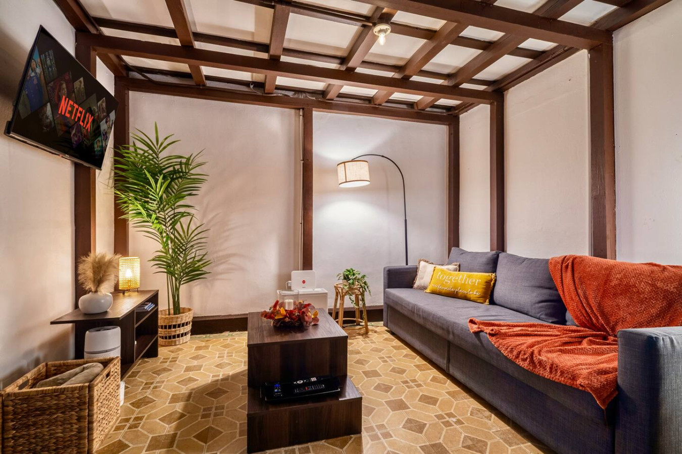 Living room with a couch and a potted plant — La Cueva Loft Rustic Colonial Romance, Old San Juan