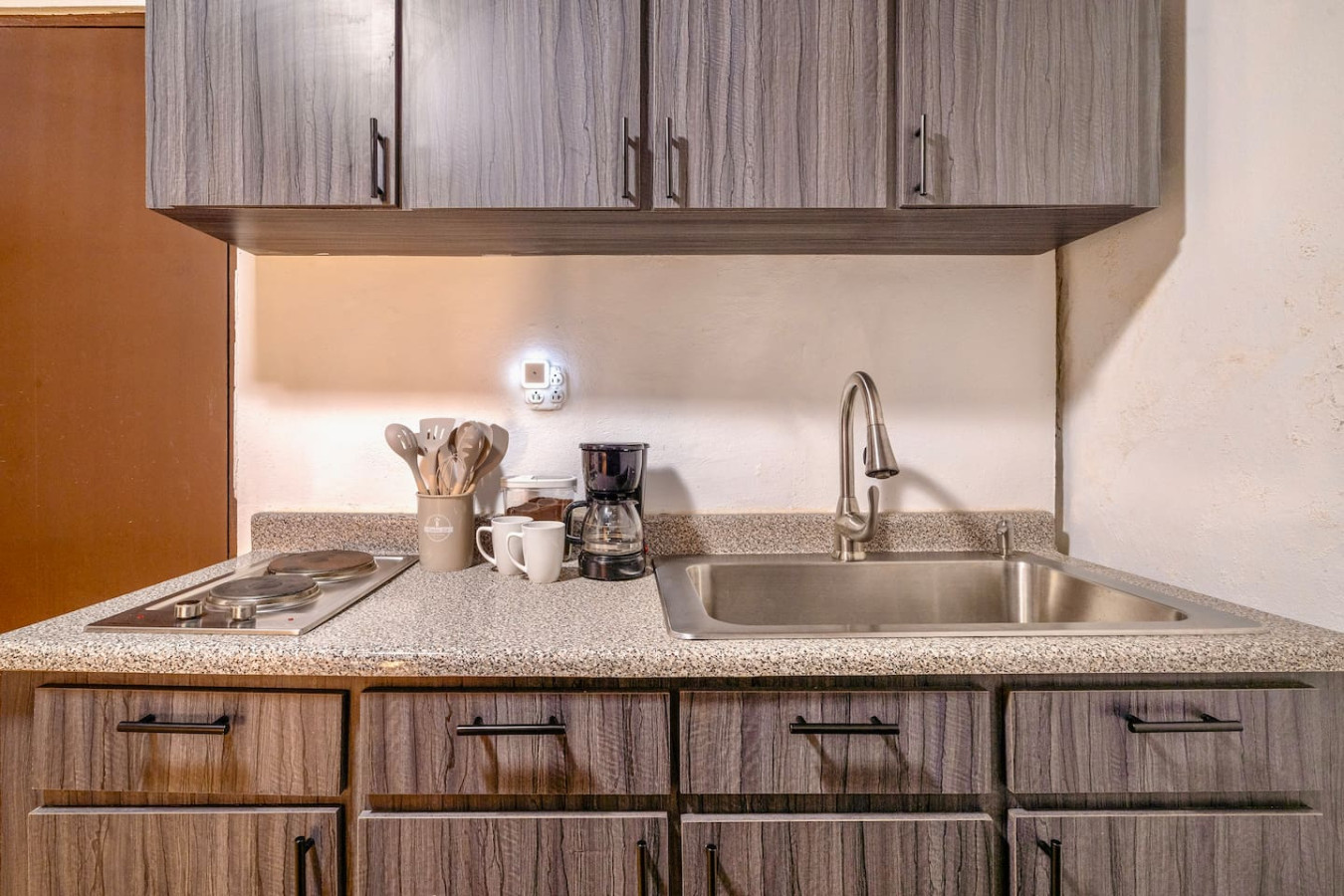 Kitchen with a sink, coffee maker, and various utensils — La Cueva Loft Rustic Colonial Romance, Old San Juan