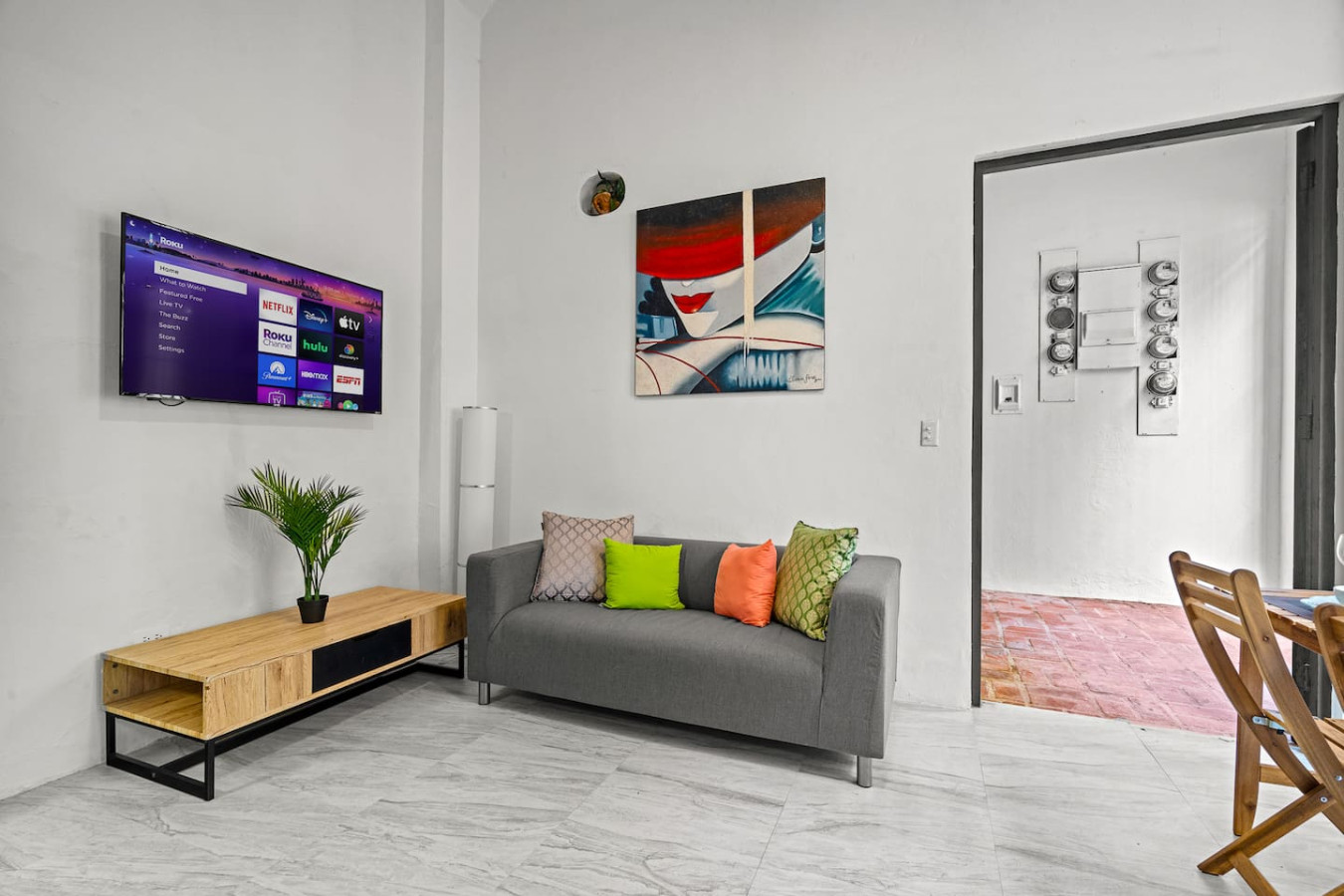 Grey couch with two pillows on it — El Balcón Art Loft – Old San Juan, Old San Juan