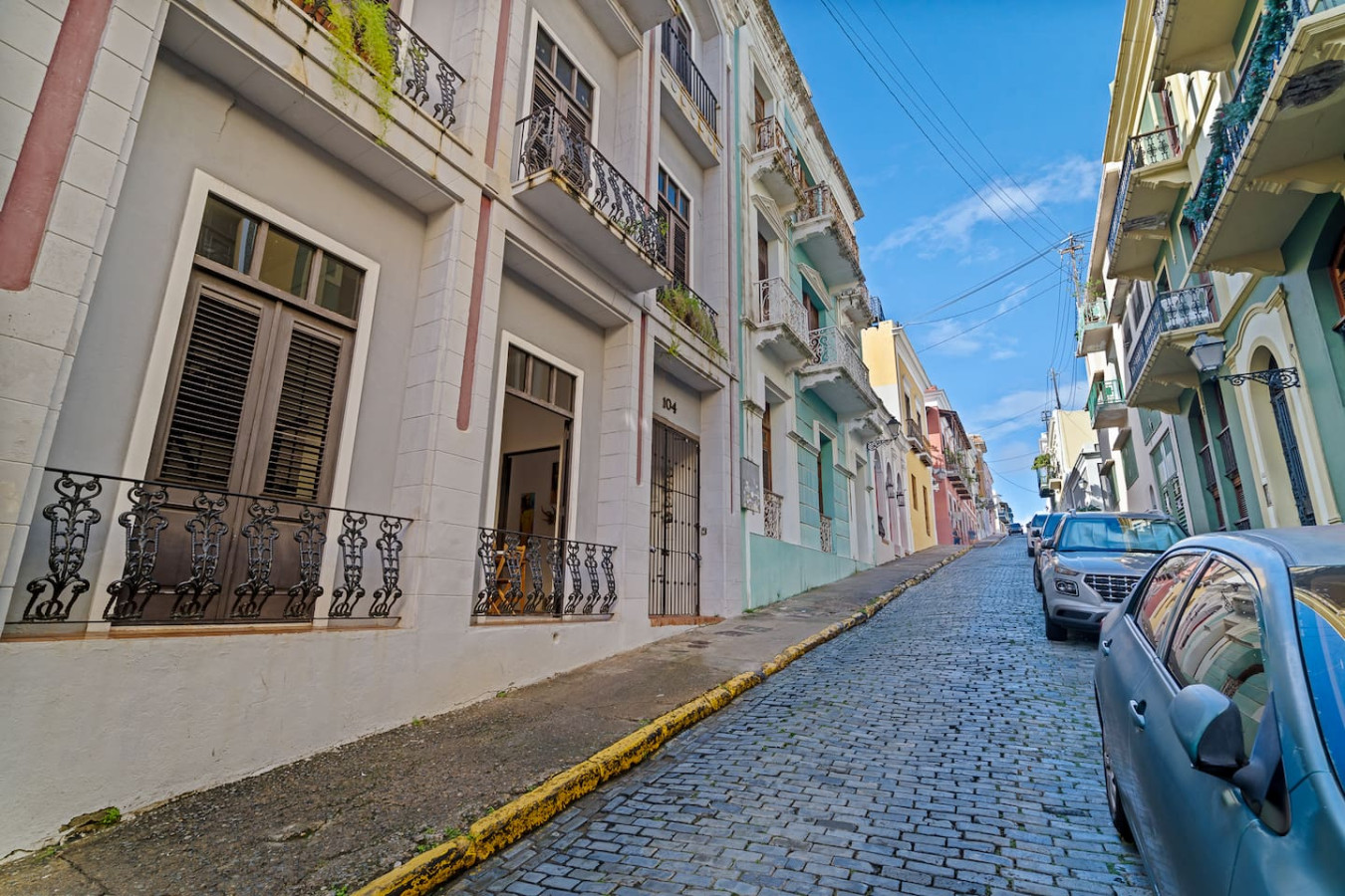 View of the street from the balcony of a vacation rental property in (exterior 2) — El Balcón Art Loft – Old San Juan, Old Sa
