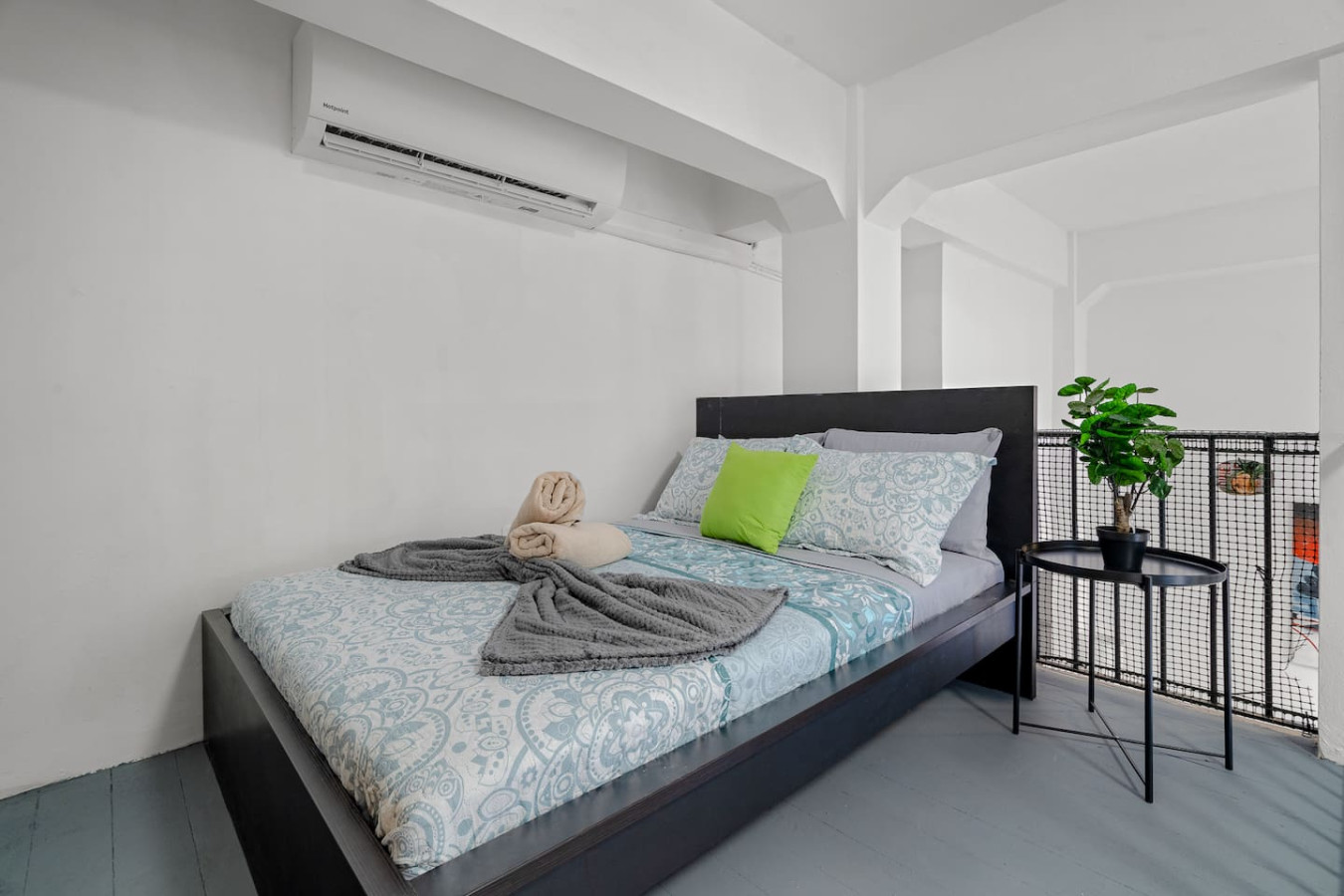 Bedroom with a bed, a chair, and a potted plant — El Balcón Art Loft – Old San Juan, Old San Juan