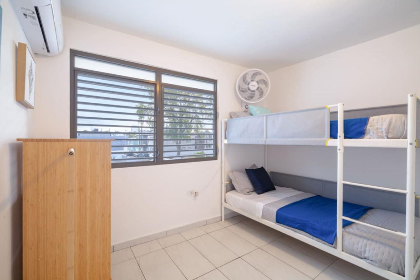 Bedroom with two beds and a fan — Casa Juno Grand Modern - 3 Bedroom - Walk to Beach, Santurce
