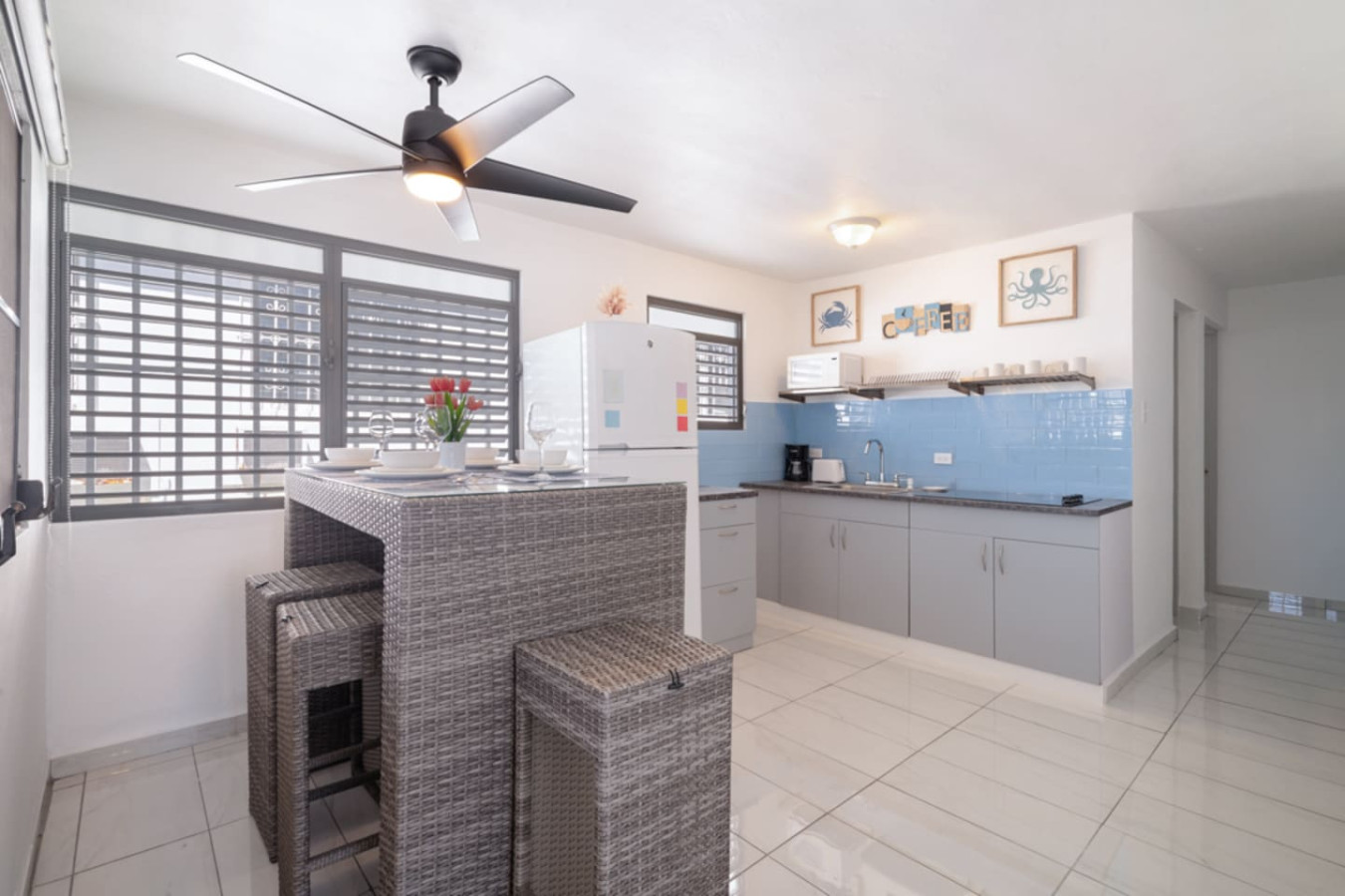 Kitchen with a refrigerator and a dining table — Casa Juno Grand Modern - 3 Bedroom - Walk to Beach, Santurce