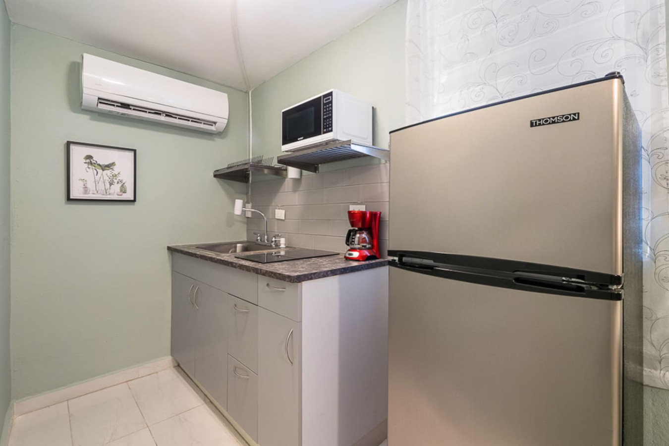 Kitchen with a sink, refrigerator, and microwave — Casa Juno I: Private Courtyard Studio, Santurce