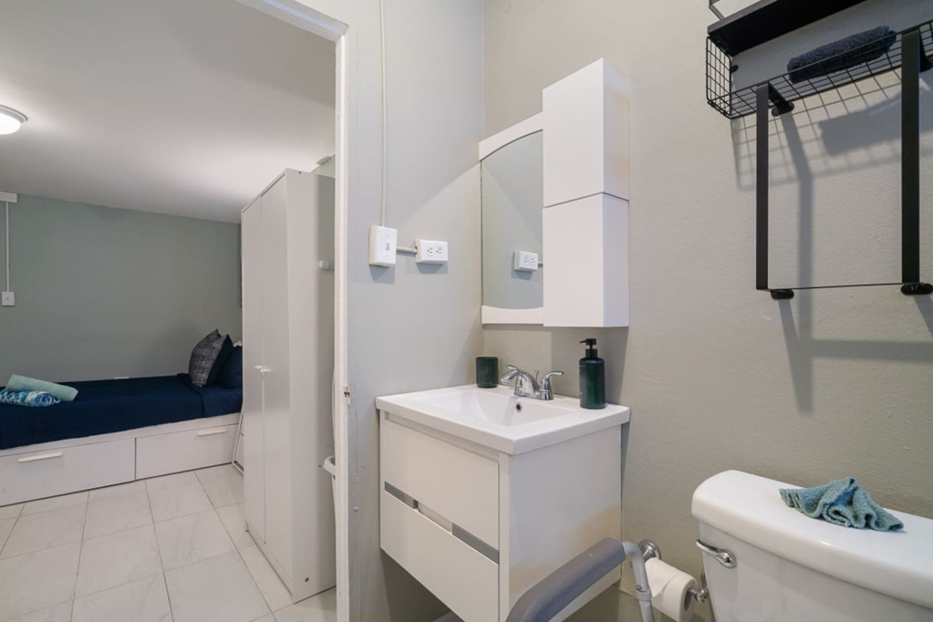 Bathroom with a sink and mirror — Casa Juno I: Private Courtyard Studio, Santurce