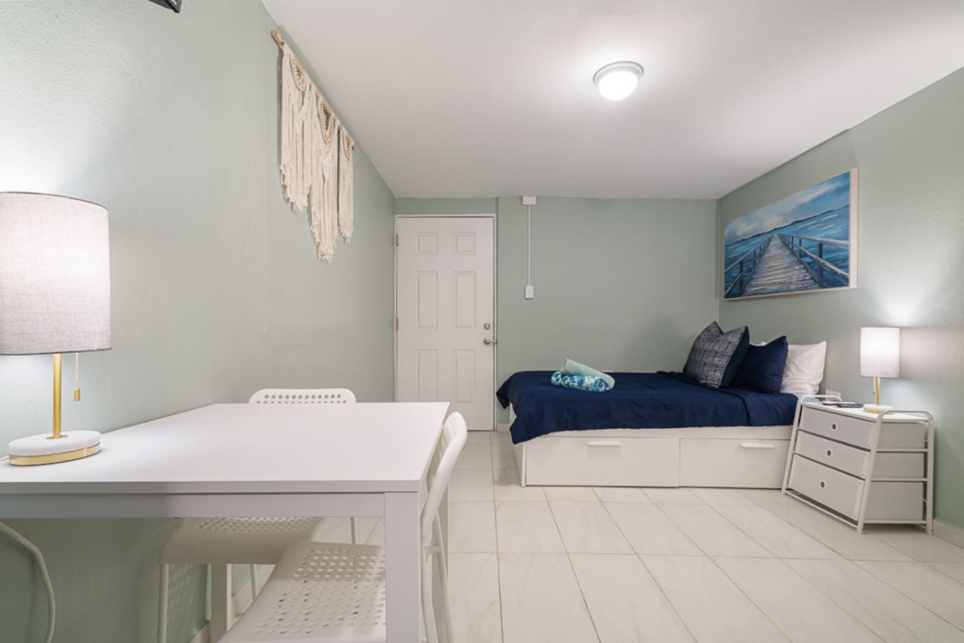 Bedroom with a bed and a table — Casa Juno I: Private Courtyard Studio, Santurce