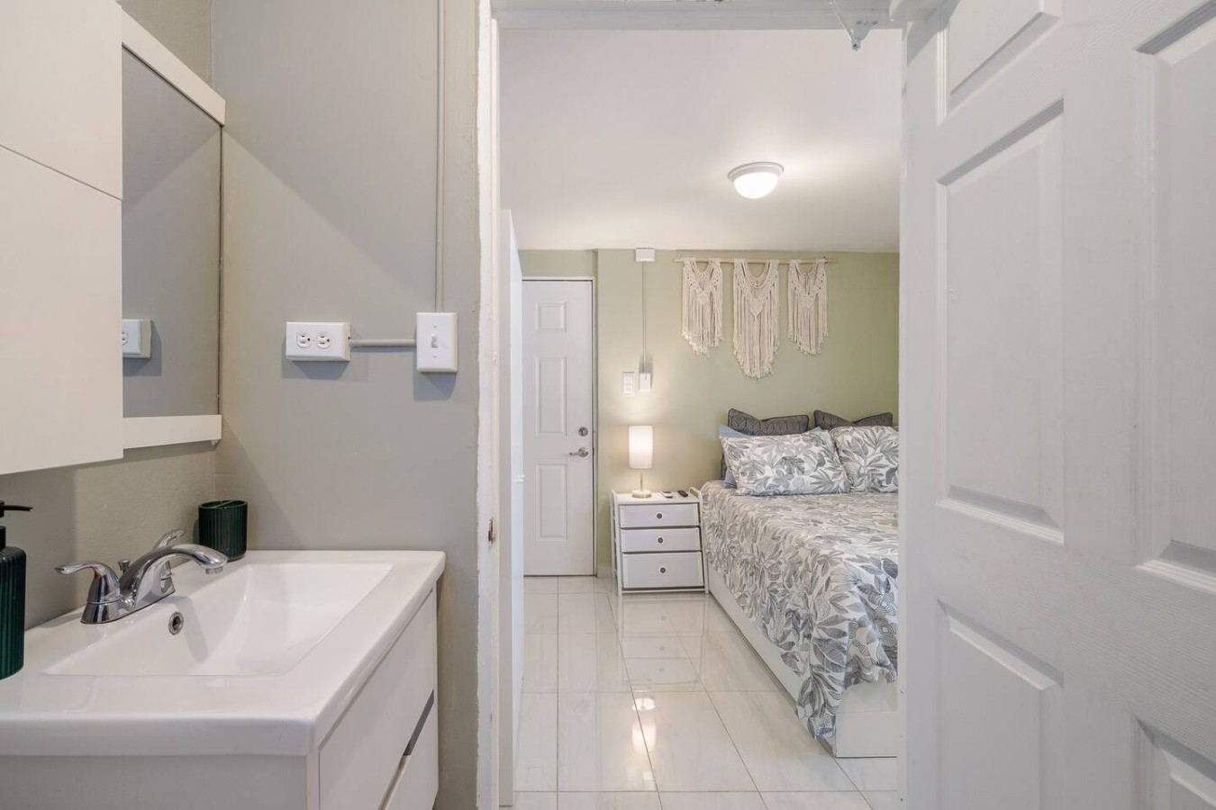 Bedroom with a bed, dresser, and light — Romero Studio San juan near beach, Santurce