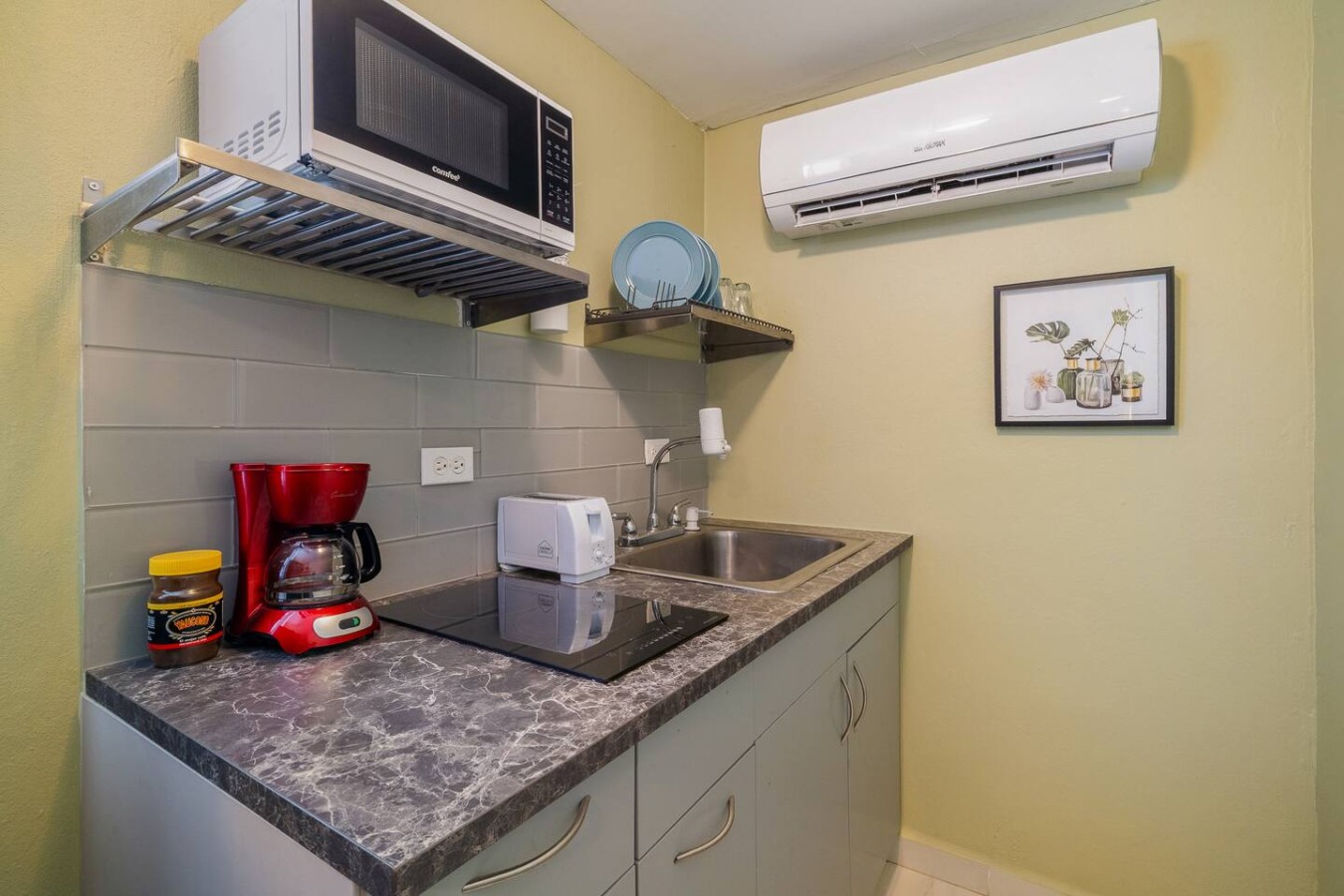 Kitchen with a microwave and a sink — Romero Studio San juan near beach, Santurce