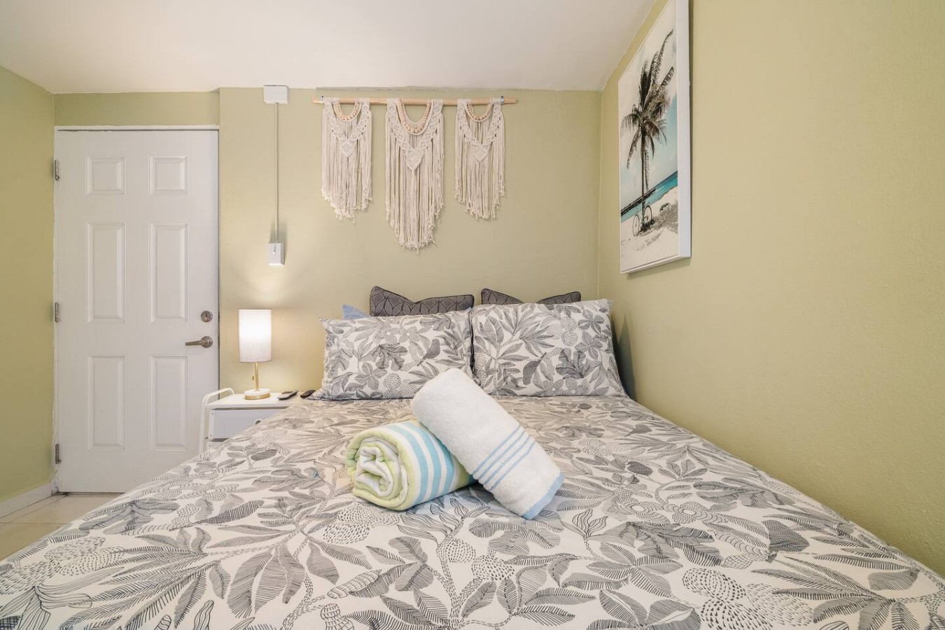 Bedroom with a bed, a lamp, and a towel on it — Romero Studio San juan near beach, Santurce