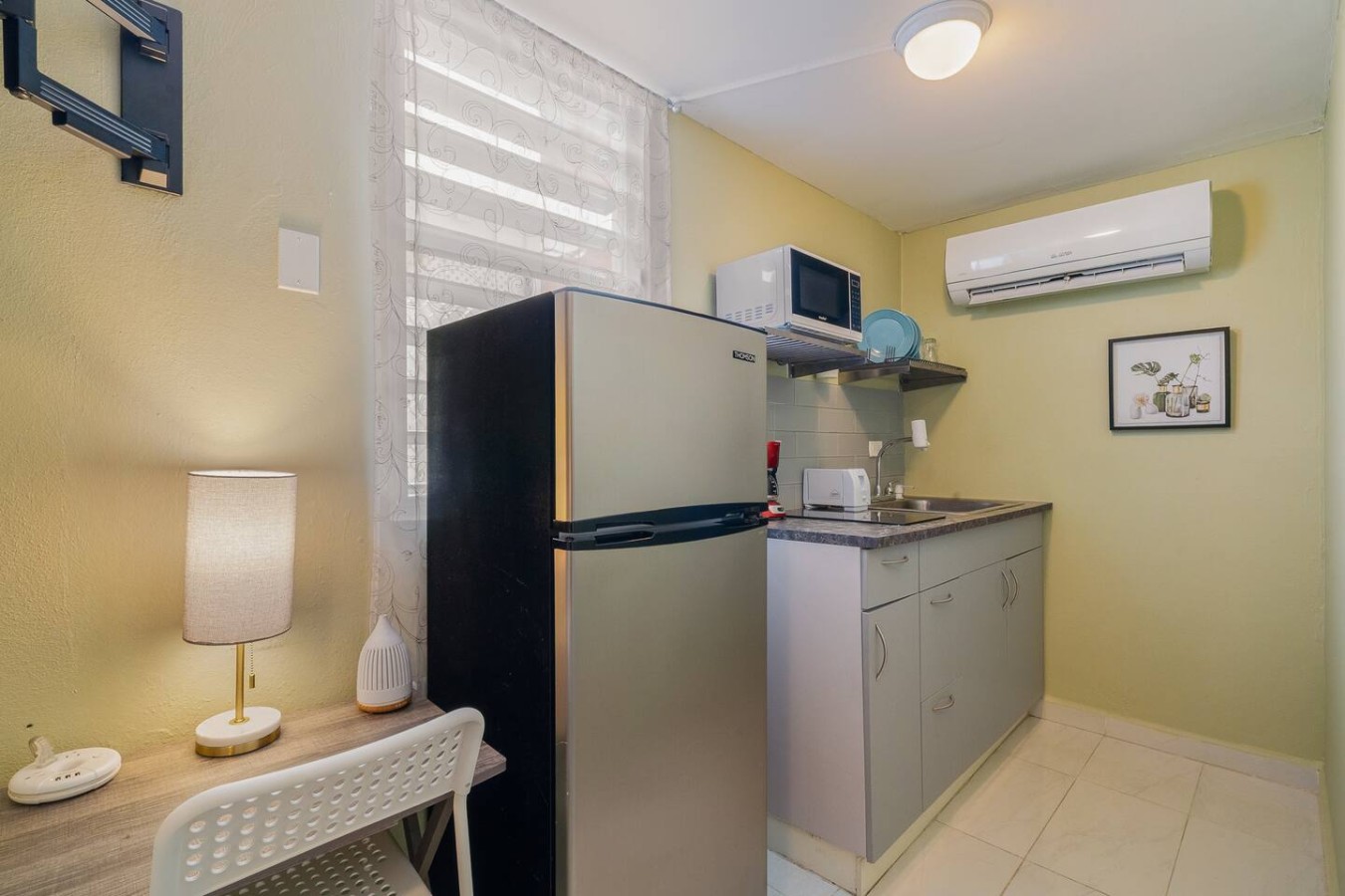 Kitchen with a refrigerator, microwave, and sink — Romero Studio San juan near beach, Santurce