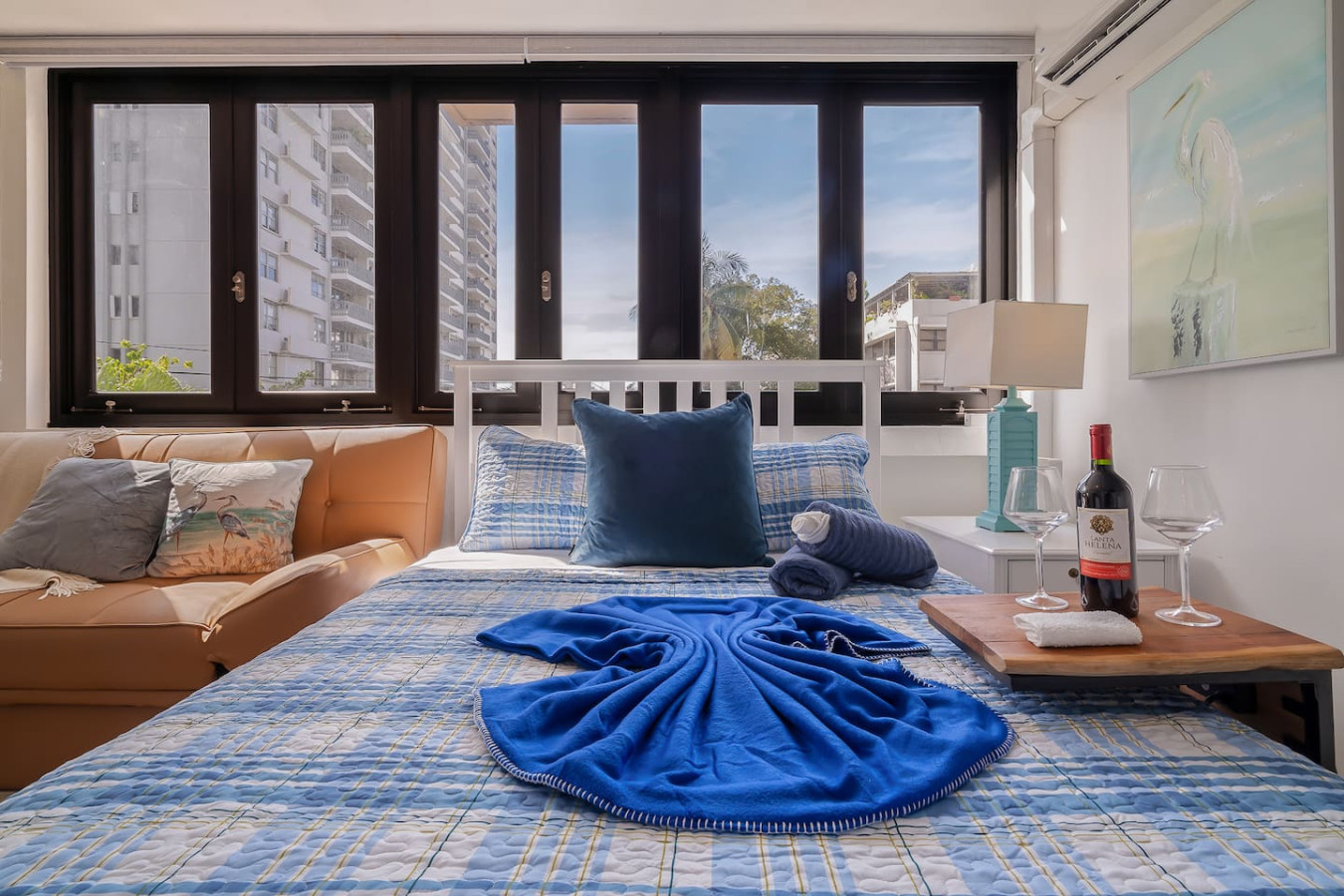 Bedroom with a blue blanket on the bed — Luxe Beachside Oasis: Pool Parking & Generator, Santurce