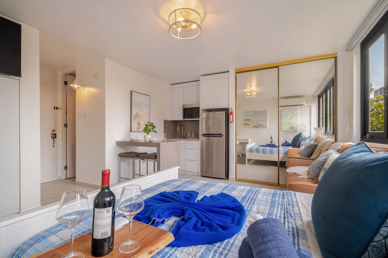 Kitchen with a refrigerator, sink, and a potted plant on the — Luxe Beachside Oasis: Pool Parking & Generator, Santurce