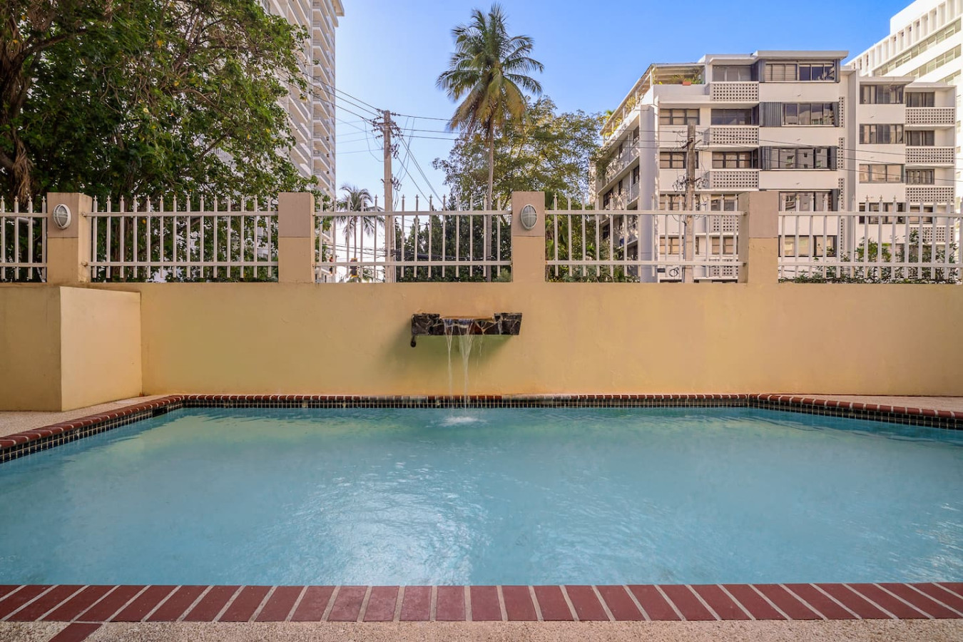 Pool with water flowing out of it — Luxe Beachside Oasis: Pool Parking & Generator, Santurce