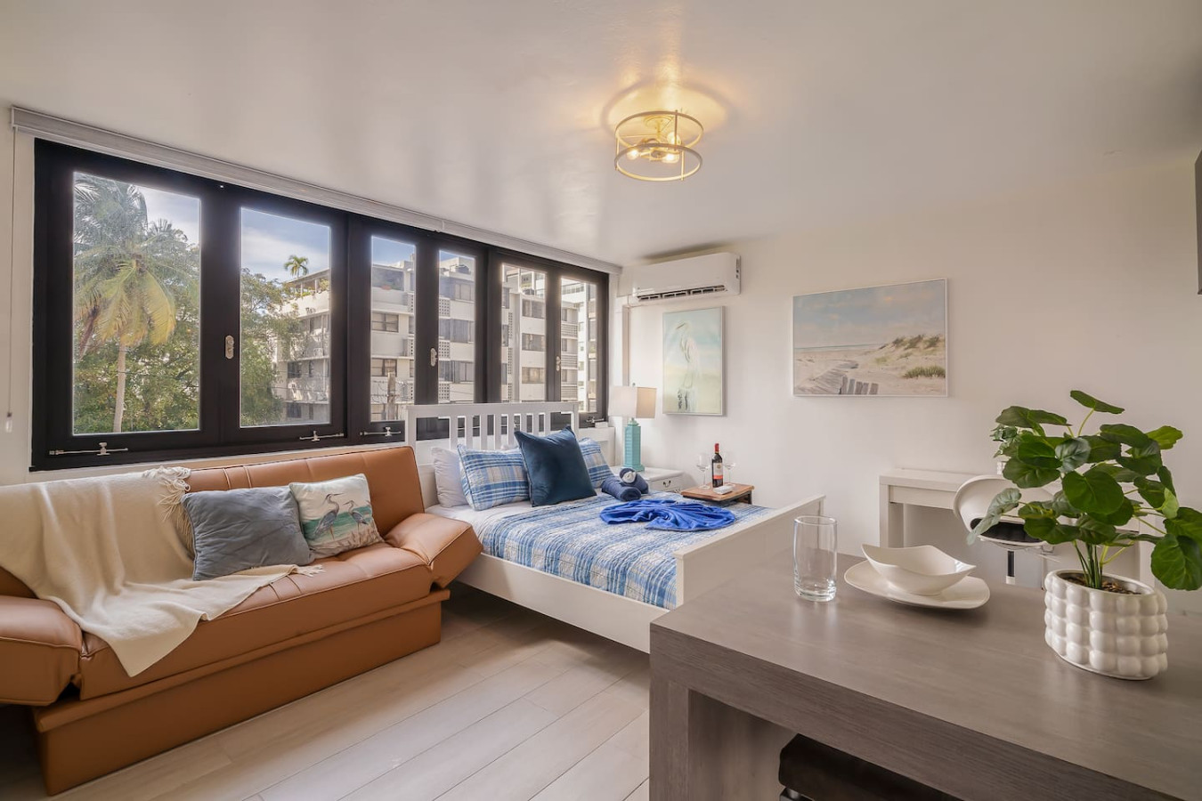 Bedroom with a couch, a table, and a painting on the wall — Luxe Beachside Oasis: Pool Parking & Generator, Santurce