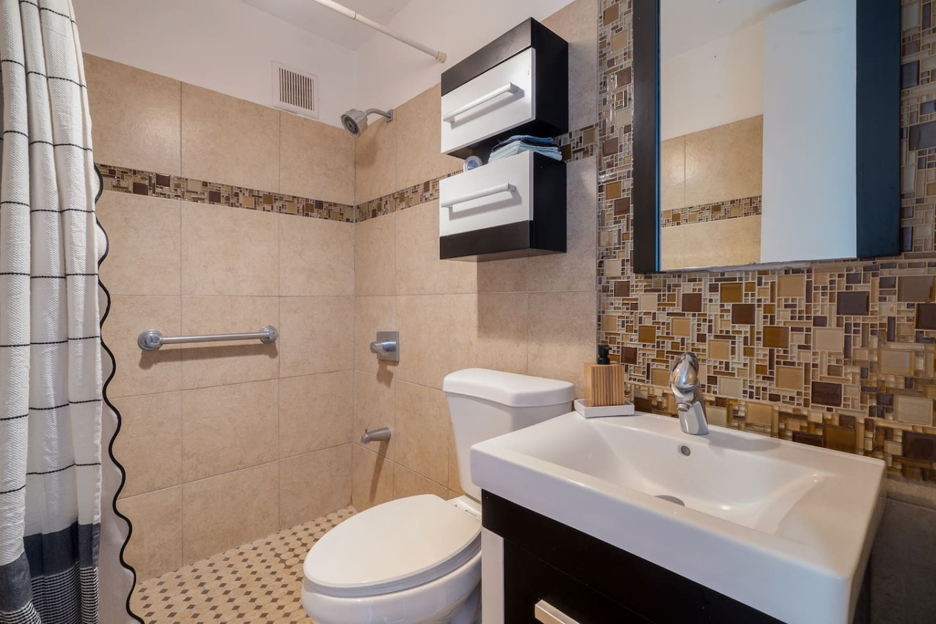 Bathroom with a tiled shower, a toilet and a sink — Luxe Beachside Oasis: Pool Parking & Generator, Santurce