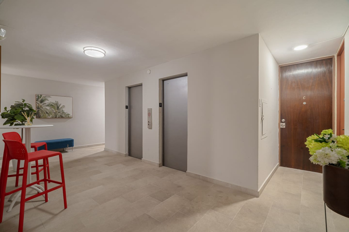 Hallway of the building with elevators and seating — Luxe Beachside Oasis: Pool Parking & Generator, Santurce