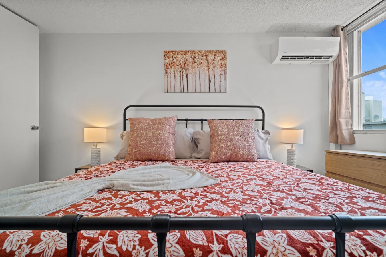Bedroom with a bed and a painting on the wall — High-Rise Condado Suite | Ocean Views & PR Skyline, Condado