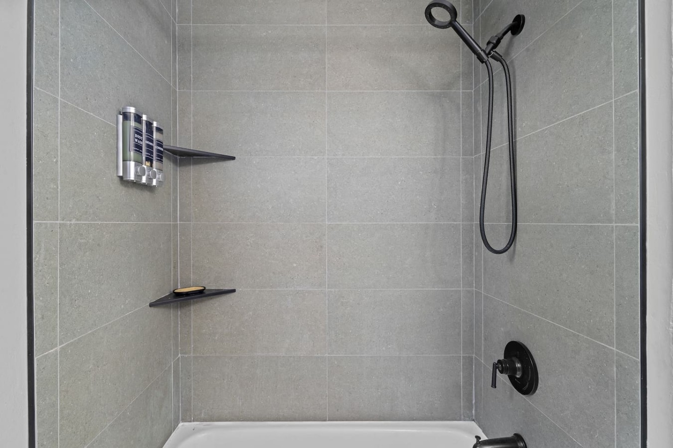 Bathroom with a tub and handheld shower — High-Rise Condado Suite | Ocean Views & PR Skyline
