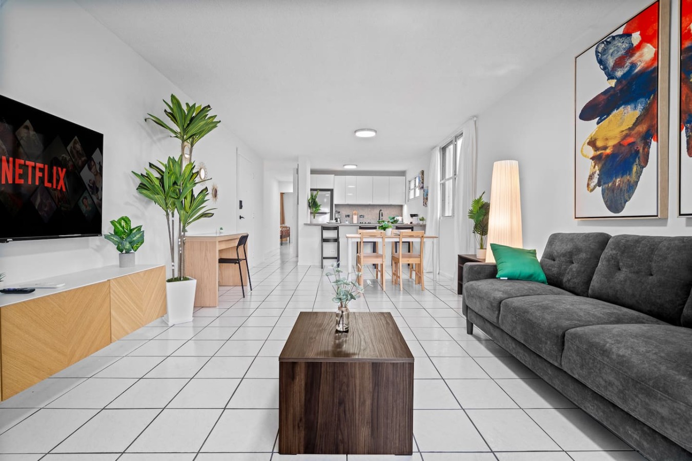 Living room with a couch, coffee table, and potted plants — High-Rise Condado Suite | Ocean Views & PR Skyline, Condado
