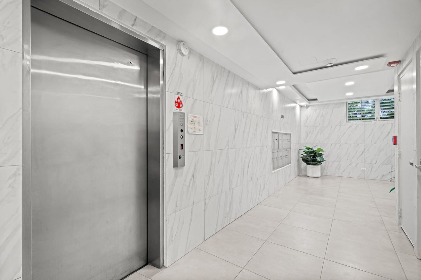 Elevator in the building's marble lobby — High-Rise Condado Suite | Ocean Views & PR Skyline