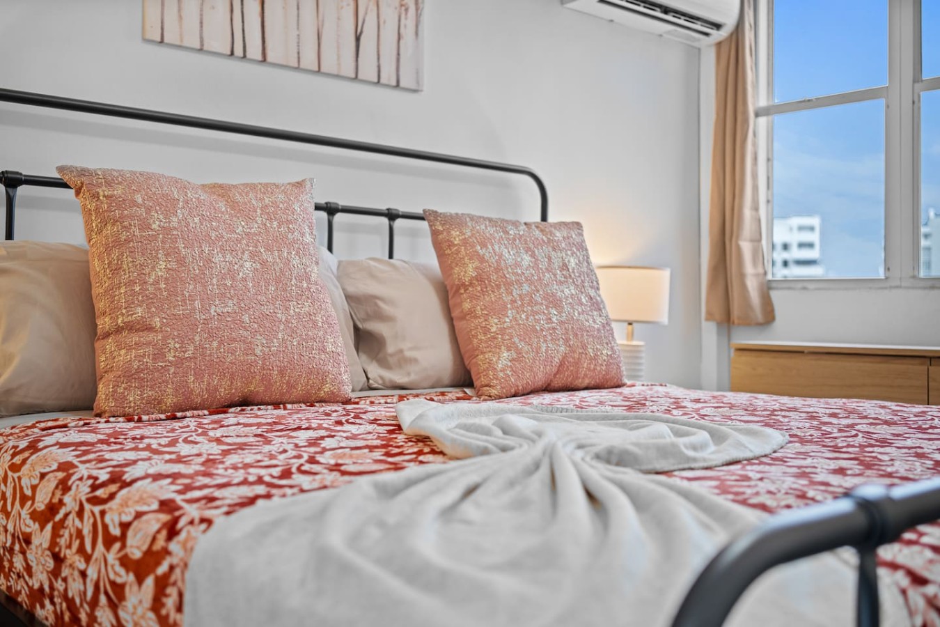 Bedroom with a bed and a lamp — High-Rise Condado Suite | Ocean Views & PR Skyline, Condado