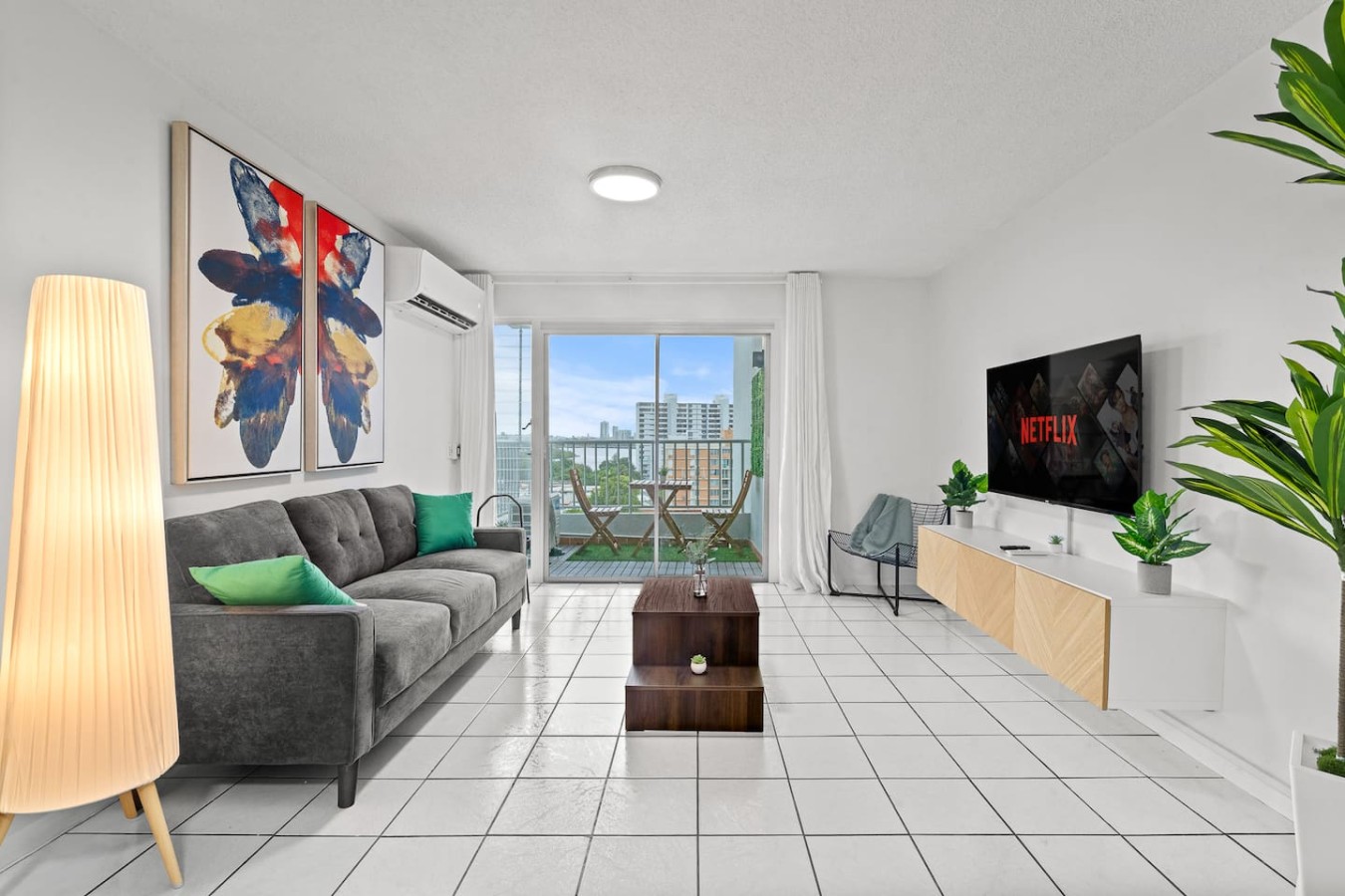 Living room with a couch, a chair, and a flat screen TV — High-Rise Condado Suite | Ocean Views & PR Skyline, Condado
