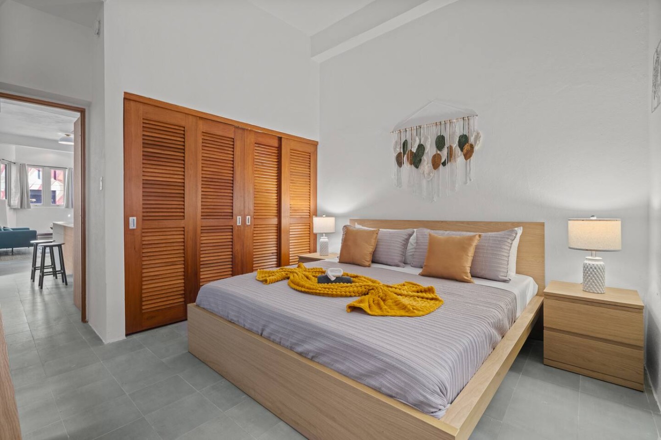 Bedroom with a bed and a yellow blanket on it — The Galleria House | Private Patio Old San Juan, Old San Juan