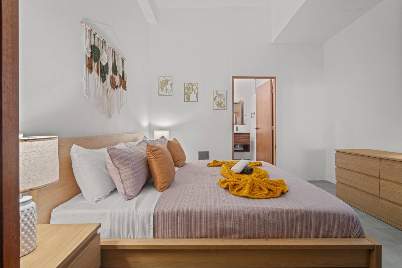 Bedroom with a bed, pillows, and a yellow blanket on it — The Galleria House | Private Patio Old San Juan, Old San Juan