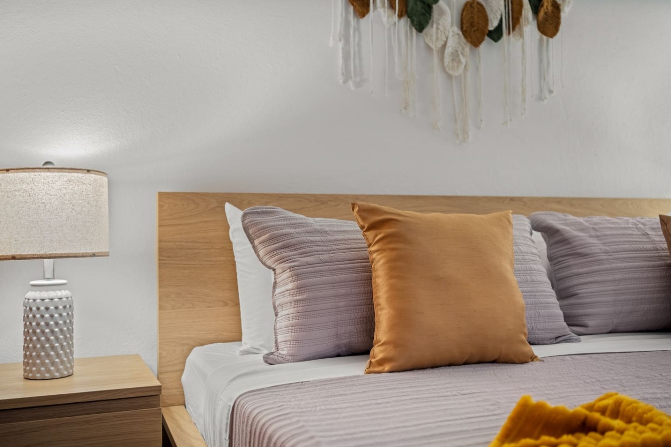 Bedroom with a wooden headboard and a white bedspread — The Galleria House | Private Patio Old San Juan, Old San Juan