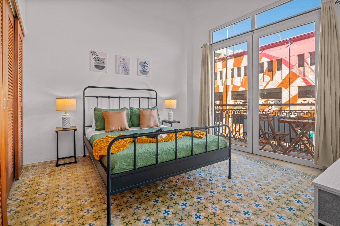 Bedroom with a black bed and a window view — The Galleria House | Private Patio Old San Juan, Old San Juan
