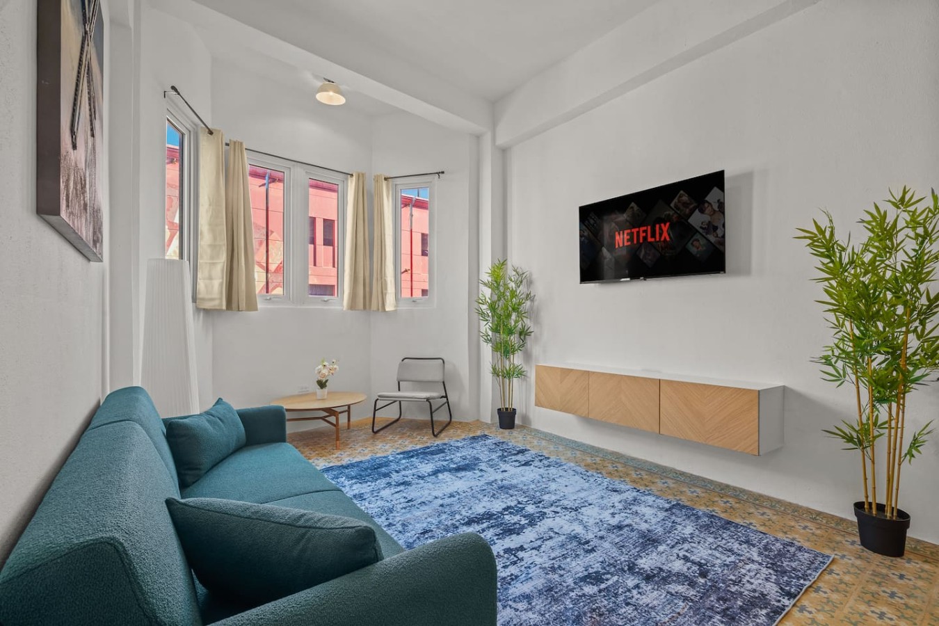 Living room with a couch and a flat screen TV — The Galleria House | Private Patio Old San Juan, Old San Juan