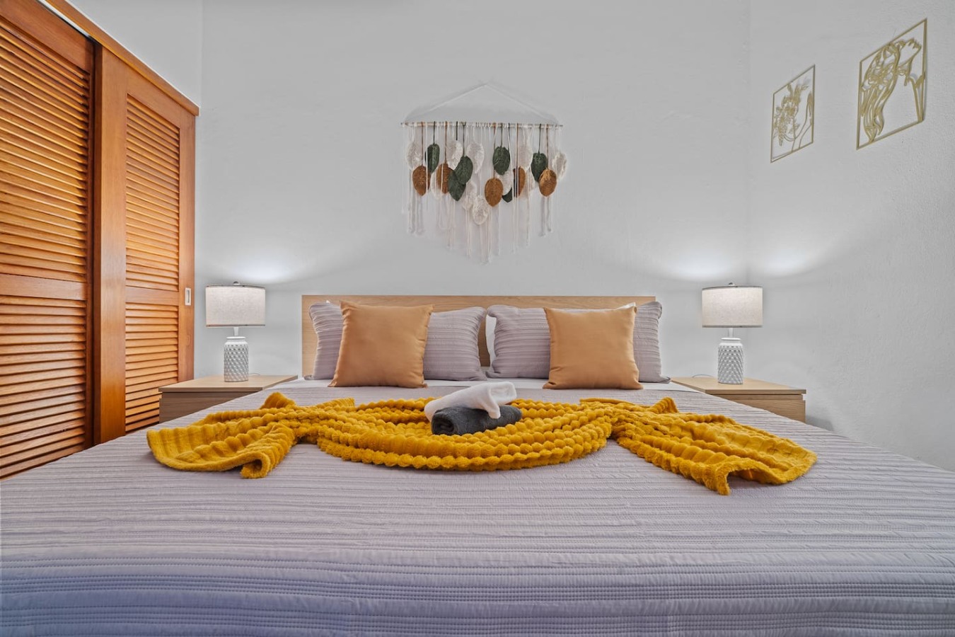 Bedroom with a yellow blanket on the bed and a phone on the — The Galleria House | Private Patio Old San Juan, Old San Juan