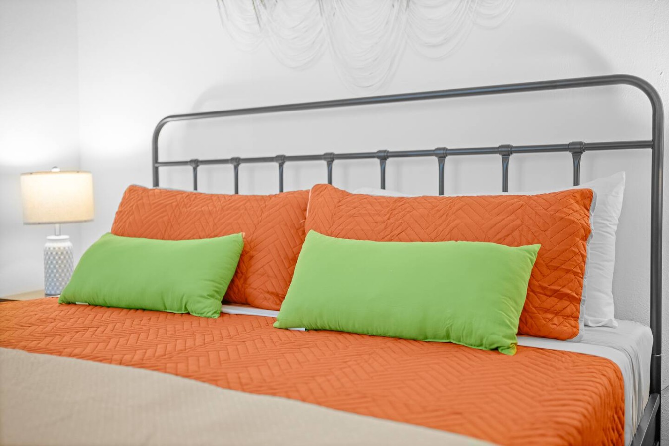 Bedroom with two orange pillows on a bed — Bellavista Galleria | Old San Juan, Old San Juan