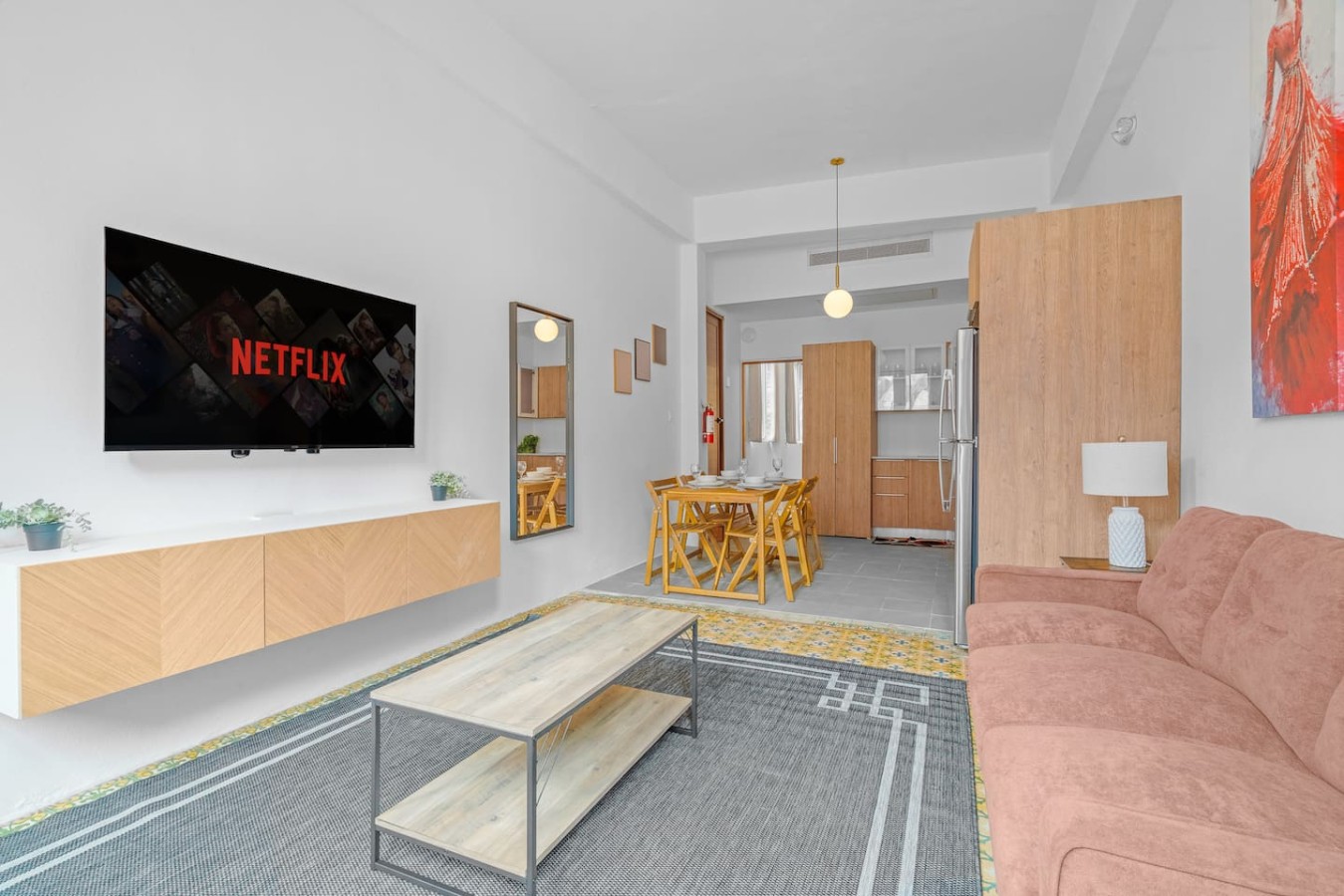 Living room with a flat screen TV and a wooden coffee table — Bellavista Galleria | Old San Juan