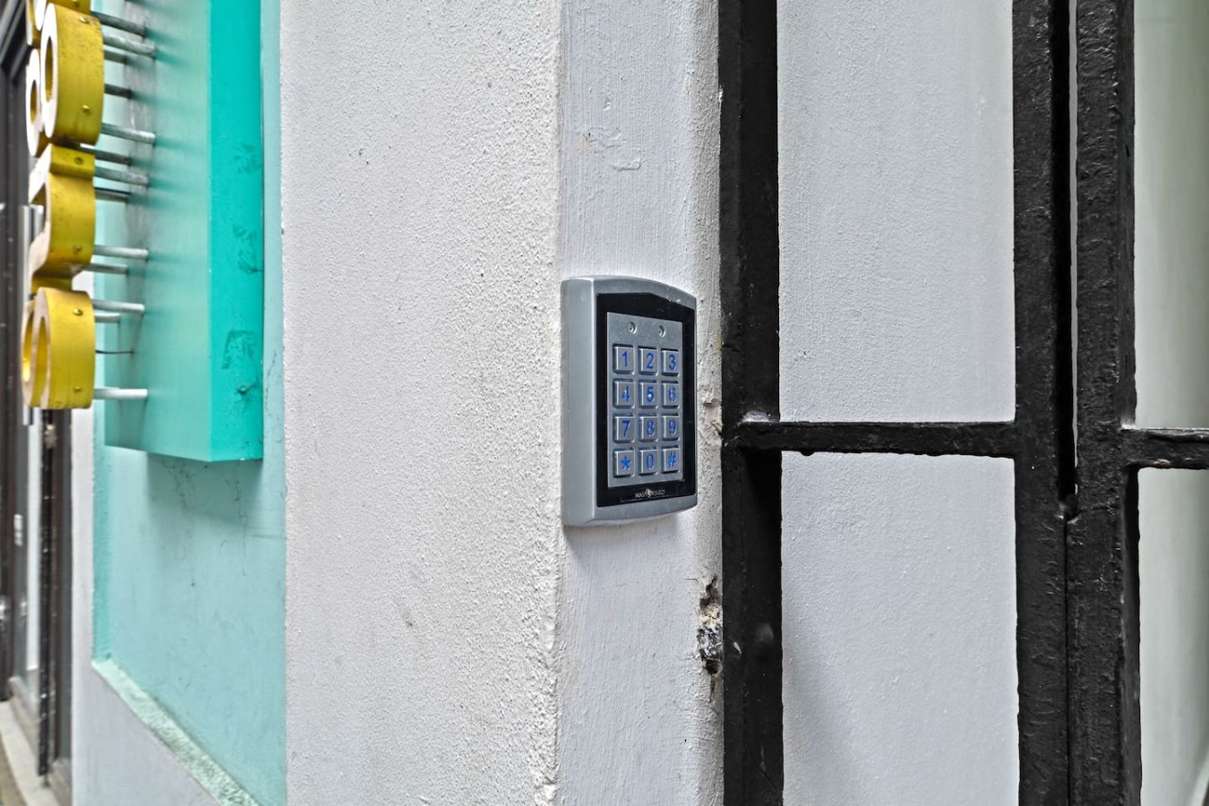 White building with a blue door and a black gate — Bellavista Galleria | Old San Juan, Old San Juan