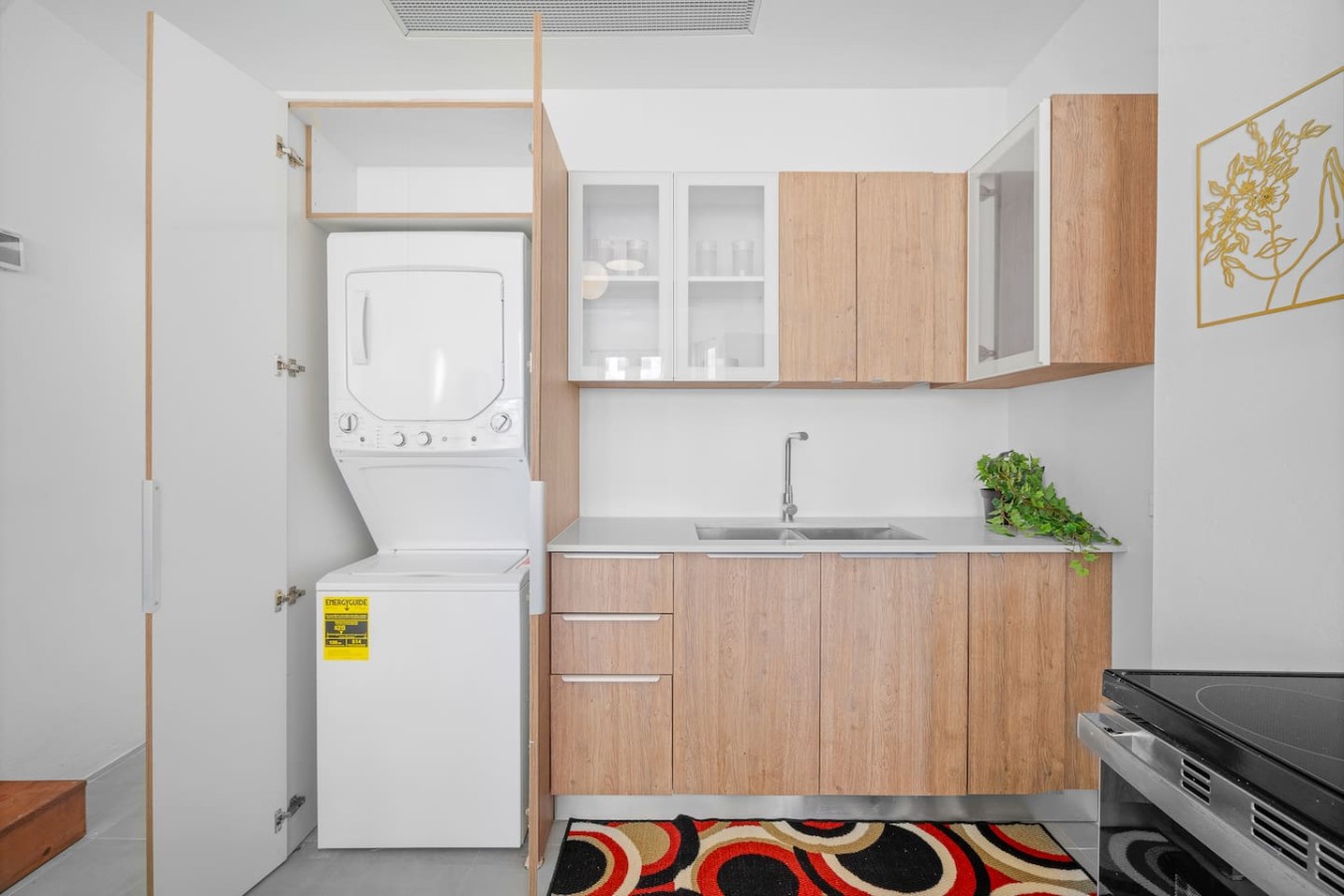Laundry closet with a stacked washer and dryer — Bellavista Galleria | Old San Juan