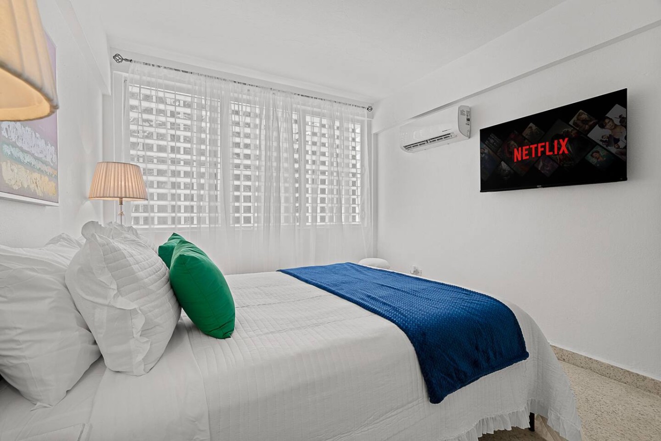 Bedroom with a white bedspread and a blue blanket — Ocean Park 2BR Backyard BBQ Walk to Beach, Santurce