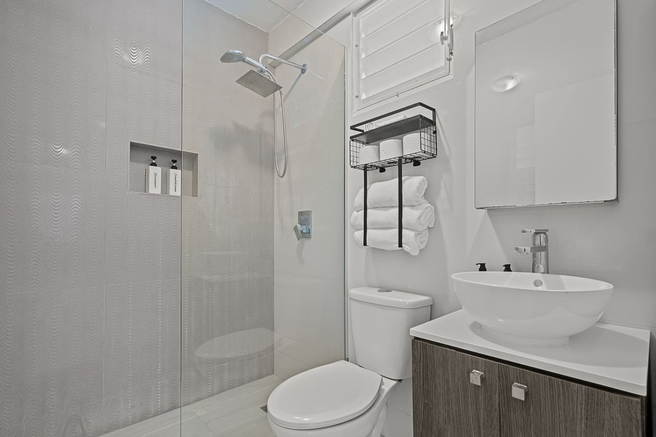 White toilet in a bathroom with a glass shower door — Ocean Park 2BR Backyard BBQ Walk to Beach, Santurce