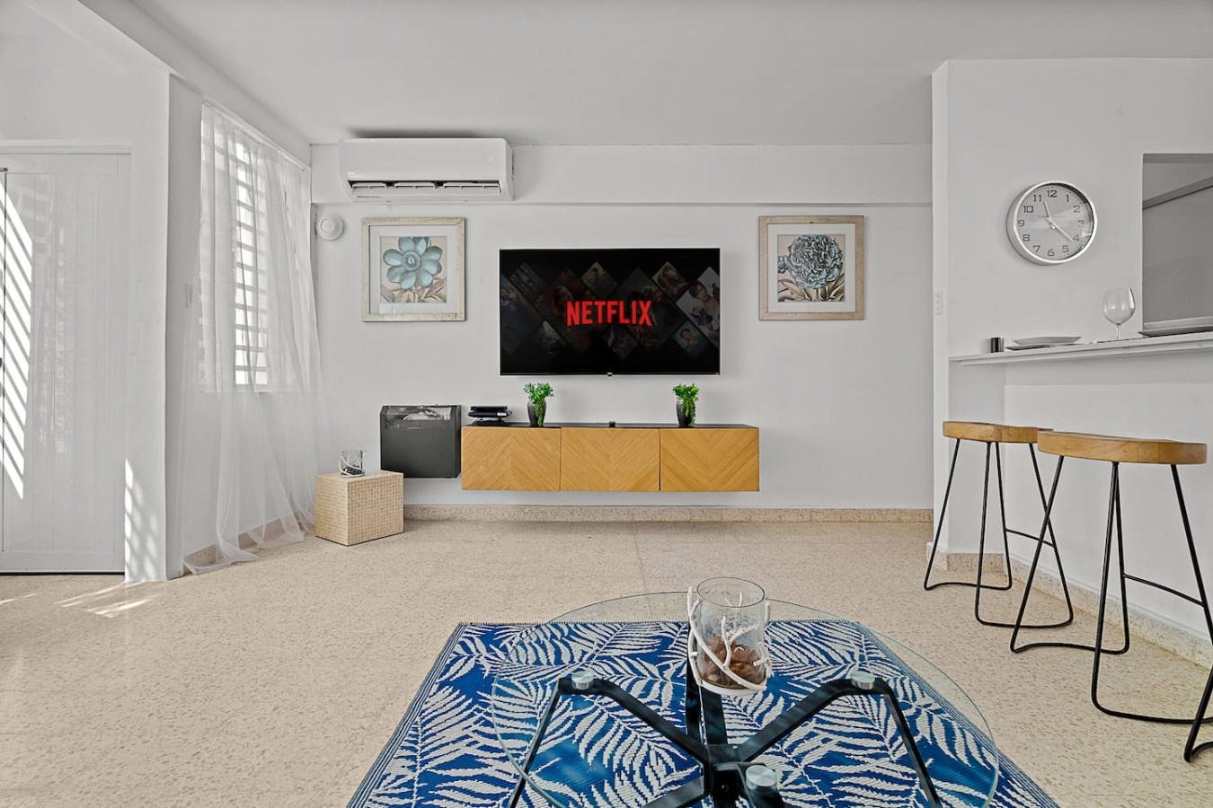 Flat screen TV on a wooden stand in a living room — Ocean Park 2BR Backyard BBQ Walk to Beach, Santurce