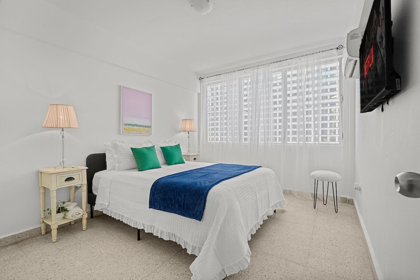 Bedroom with a blue bedspread and white curtains — Ocean Park 2BR Backyard BBQ Walk to Beach, Santurce