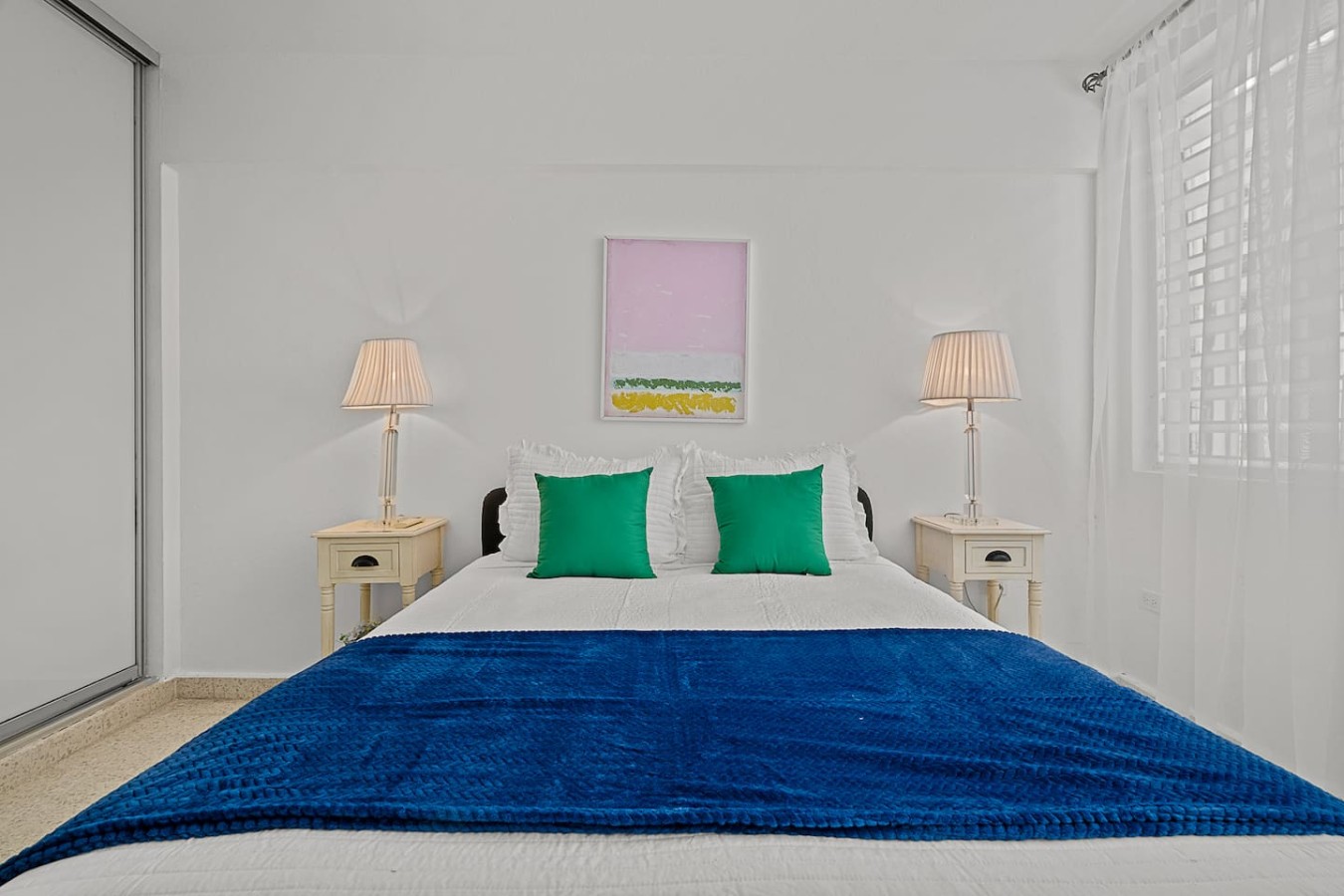 Bedroom with a blue comforter and two green pillows — Ocean Park 2BR Backyard BBQ Walk to Beach, Santurce