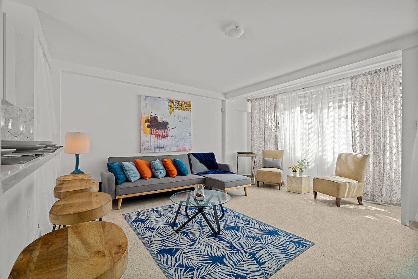 Living room with a couch, chairs, and a painting on the wall — Ocean Park 2BR Backyard BBQ Walk to Beach, Santurce