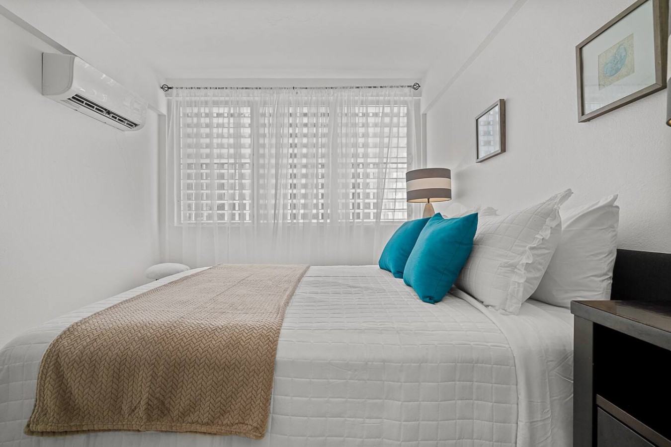 Bedroom with a white bed and blue pillows — Ocean Park 2BR Backyard BBQ Walk to Beach, Santurce