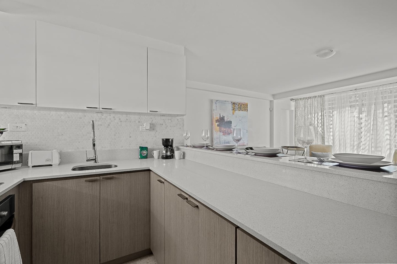 Kitchen with white cabinets and a breakfast bar — Ocean Park 2BR Backyard BBQ Walk to Beach, Santurce