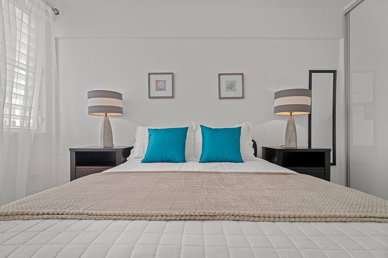Bedroom with a white bedspread and blue pillows — Ocean Park 2BR Backyard BBQ Walk to Beach, Santurce