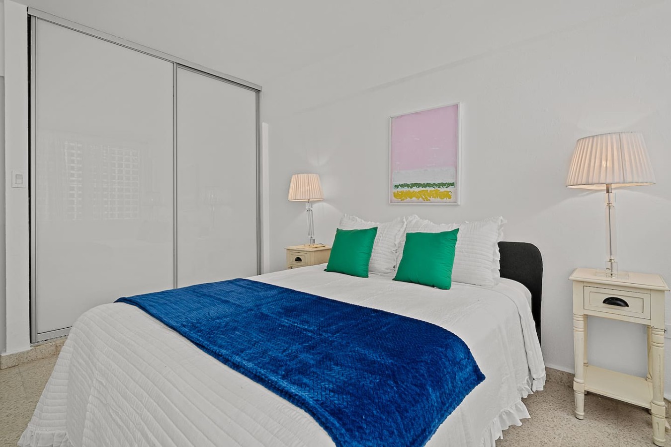 Bedroom with a blue comforter and green pillows — Ocean Park 2BR Backyard BBQ Walk to Beach, Santurce