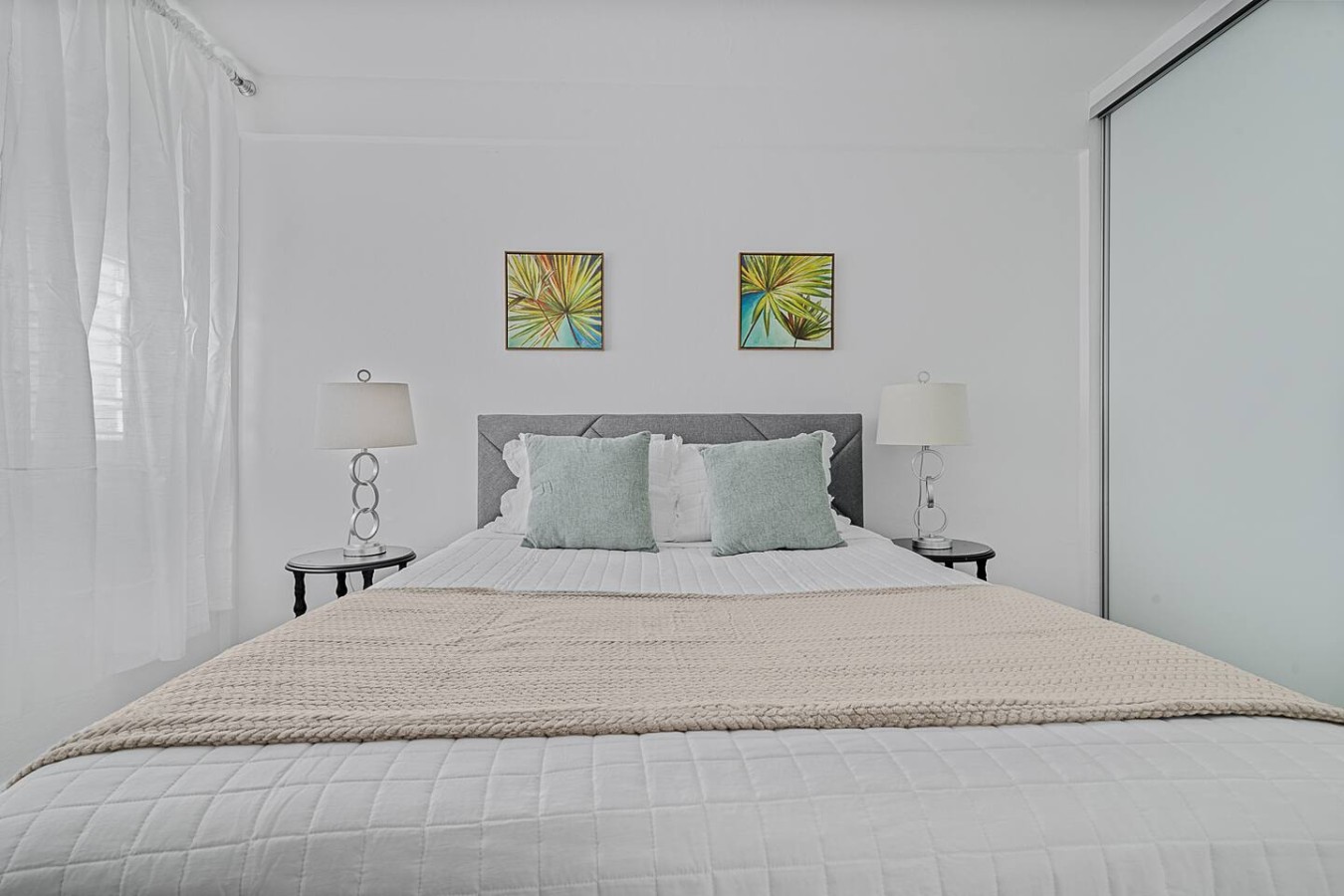 Bedroom with a white bedspread and two pillows — Ocean Park 2BR · Steps to Beach & Dining, Santurce