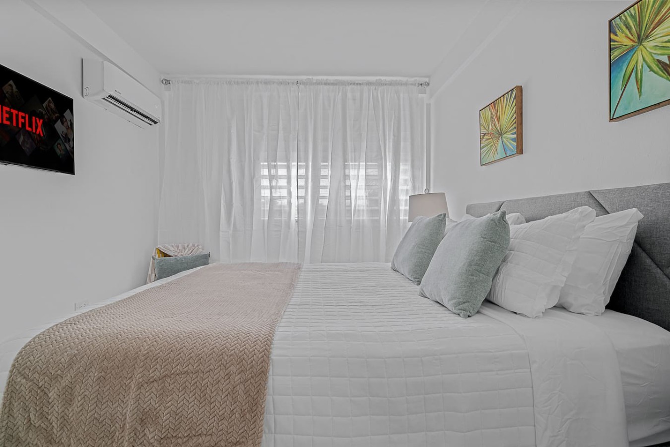 Bedroom with a white bed and a view of the ocean — Ocean Park 2BR · Steps to Beach & Dining, Santurce